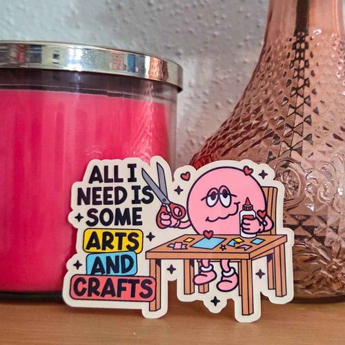 Sticker with cartoon character and text 'All I need is some arts and crafts' next to a pink candle.