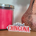 Pink candle and textured vase on a wooden surface with 'certified CHINGONA' text overlay.