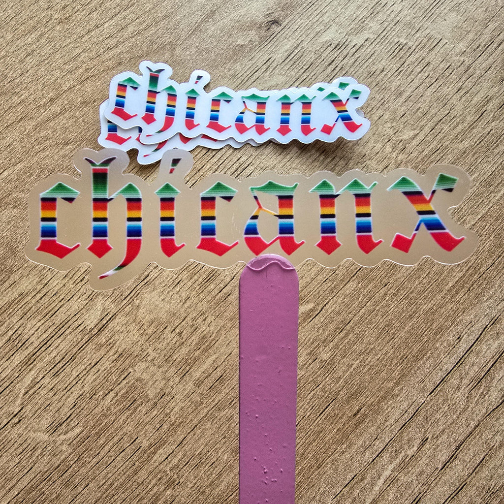 Colorful 'Chicanx' text on a wooden surface