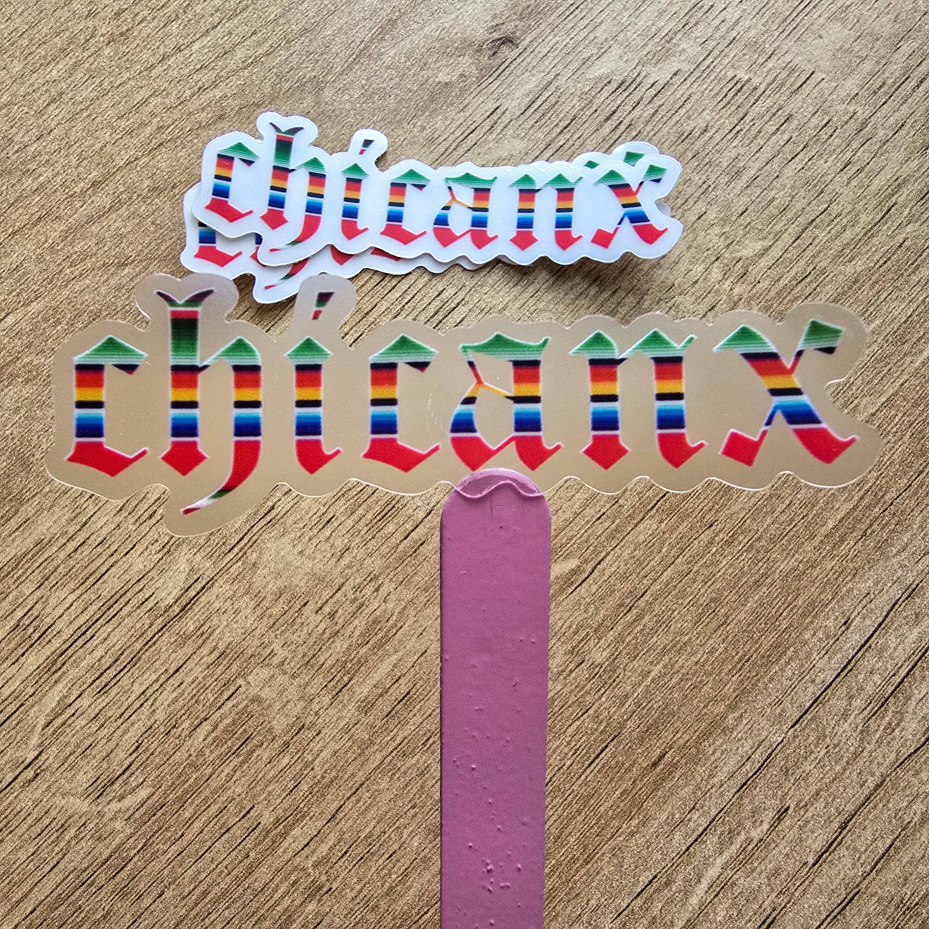 Colorful 'Chicanx' text on a wooden surface