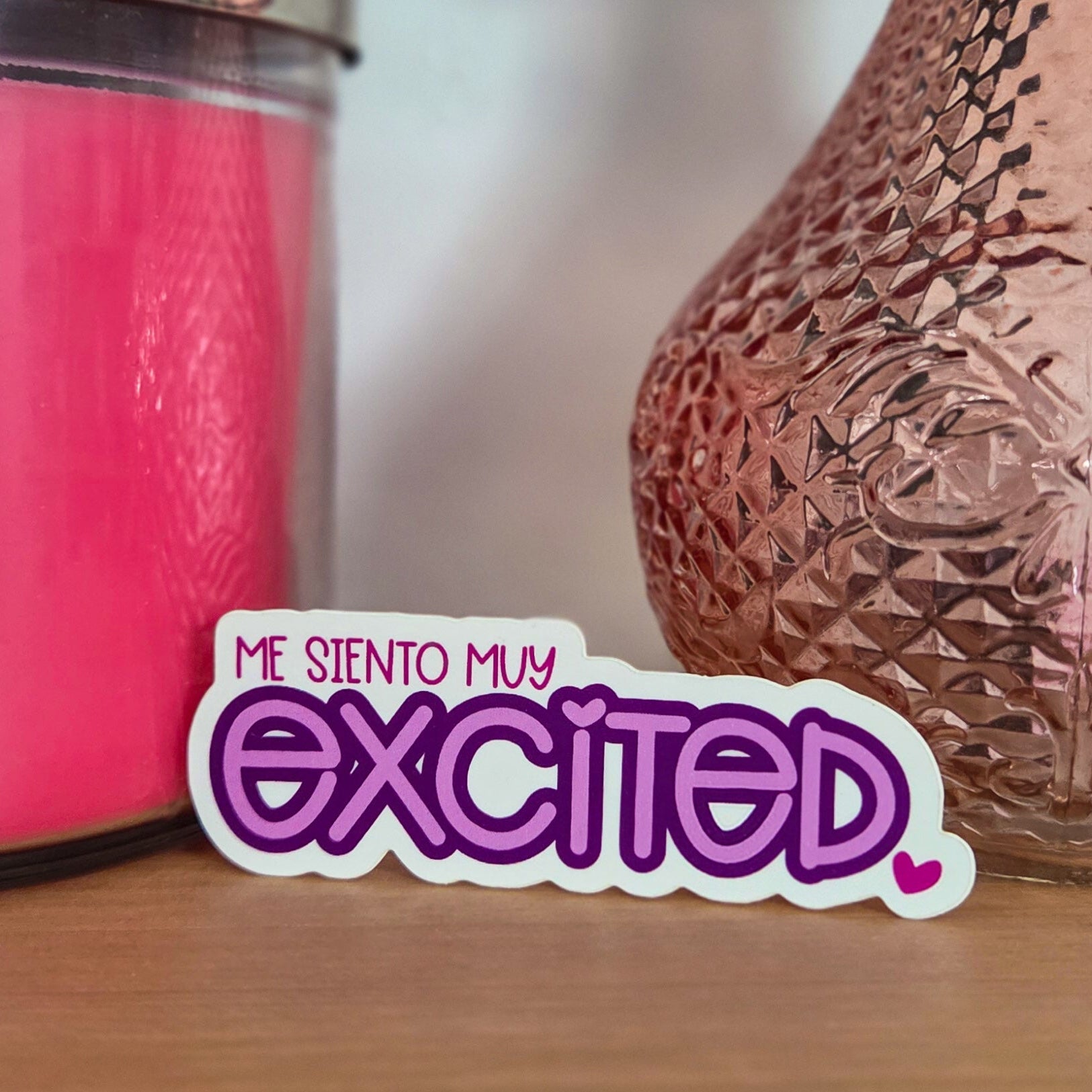 Pink textured vase and pink candle on a wooden surface with 'excited' text overlay.