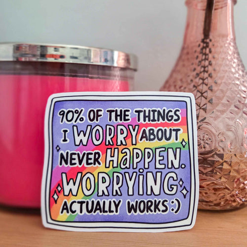 A square sticker with a colorful rainbow gradient background and bold black text reading '90% OF THE THINGS I WORRY ABOUT NEVER HAPPEN. WORRYING ACTUALLY WORKS :)'.